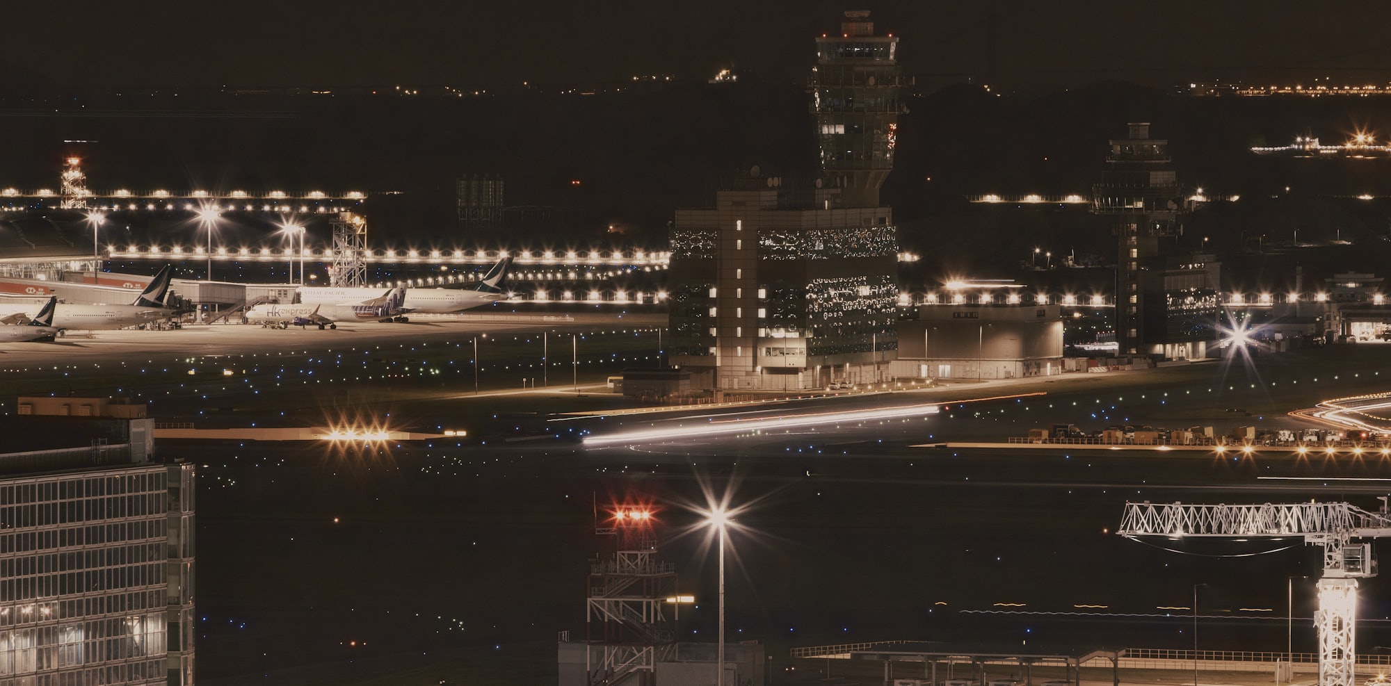 Bay Area airport at night with airplanes at the terminal